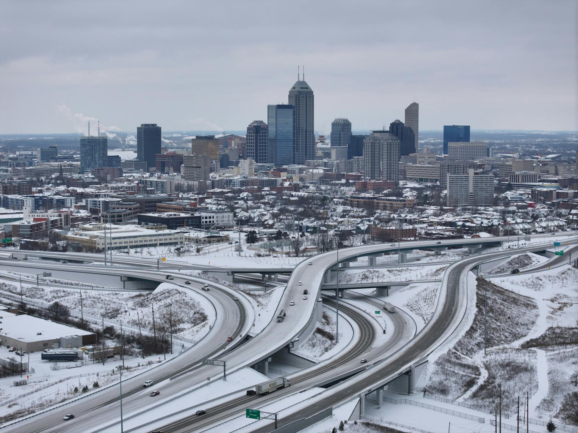 Aerial photo of the Indianapolis skyline and highways covered in snow during the winter