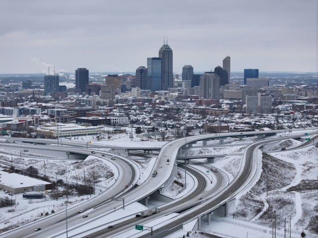 Aerial photo of the Indianapolis skyline and highways covered in snow during the winter