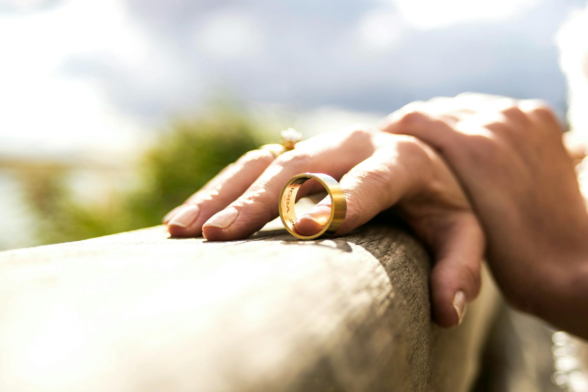 A close-up of a person who recently removed a gold wedding ring due to divorce