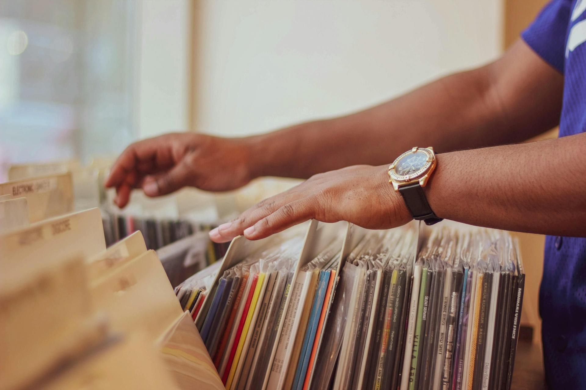 A person looking through a collection of vinyl records.