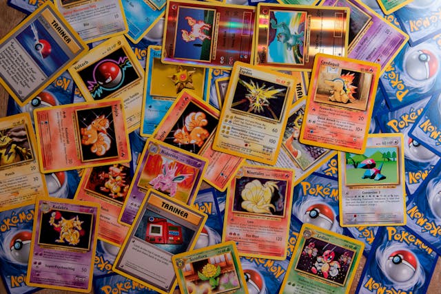 A Pokémon card collection scattered across a table.