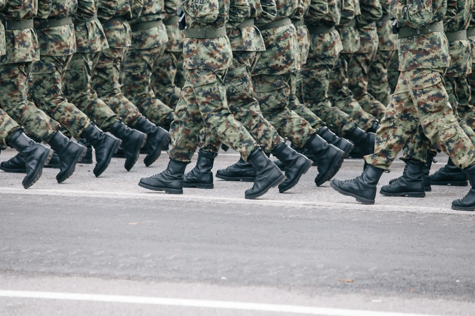 A close-up of a group of military members walking in formation.