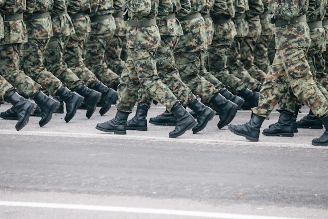 A close-up of a group of military members walking in formation.