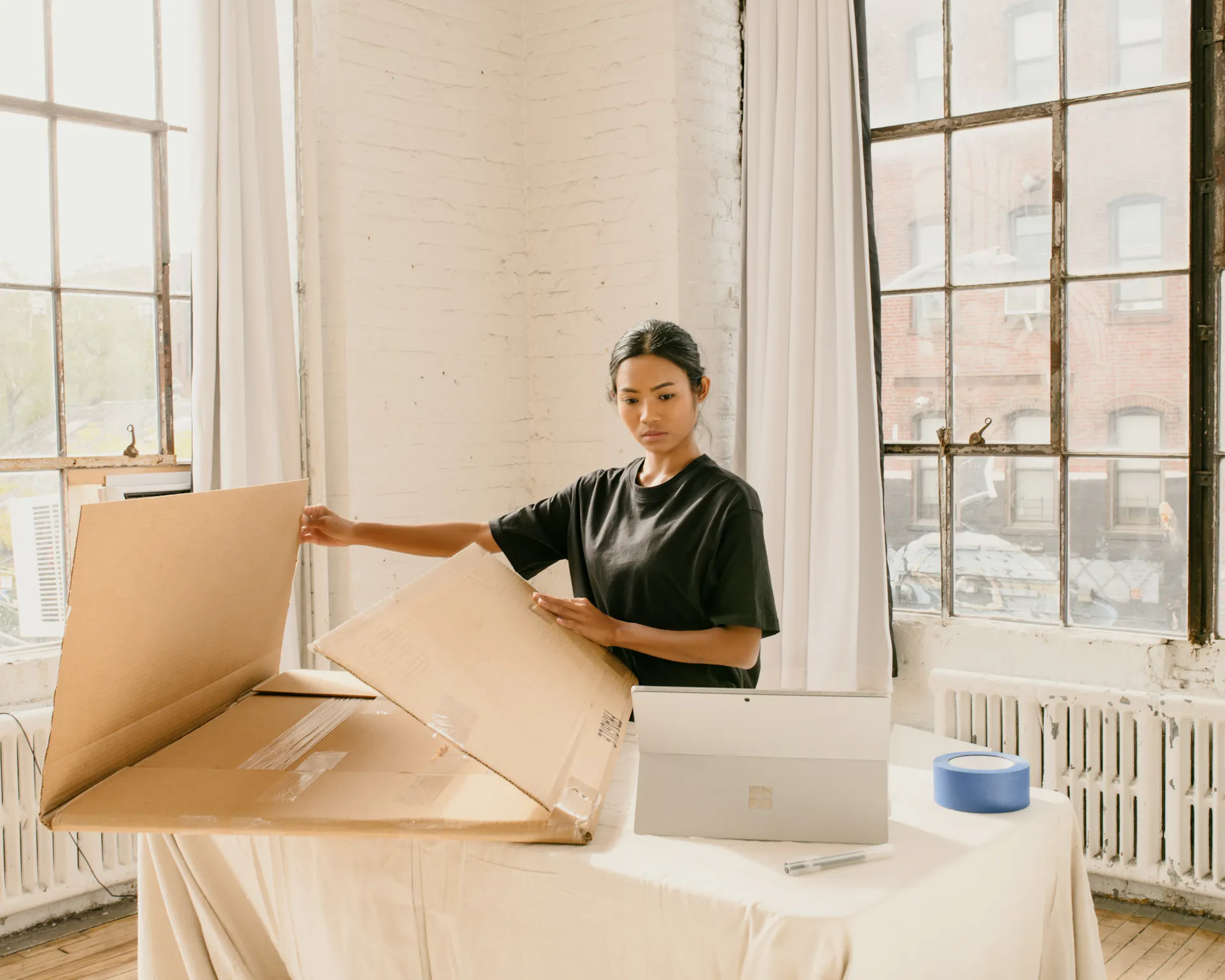 A woman packing up her belongings before a corporate relocation.