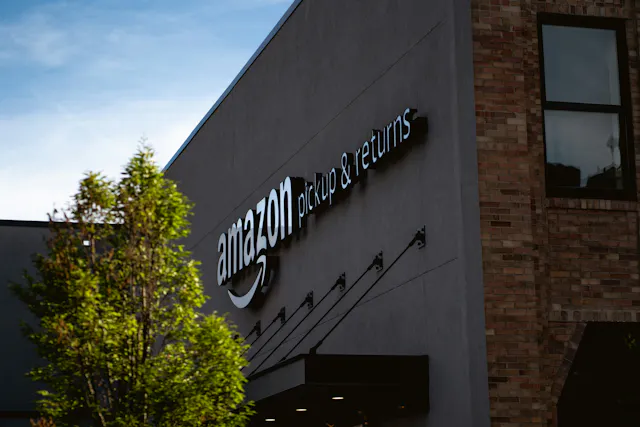 A brick building with the words “Amazon Pickups & Returns” written on it.