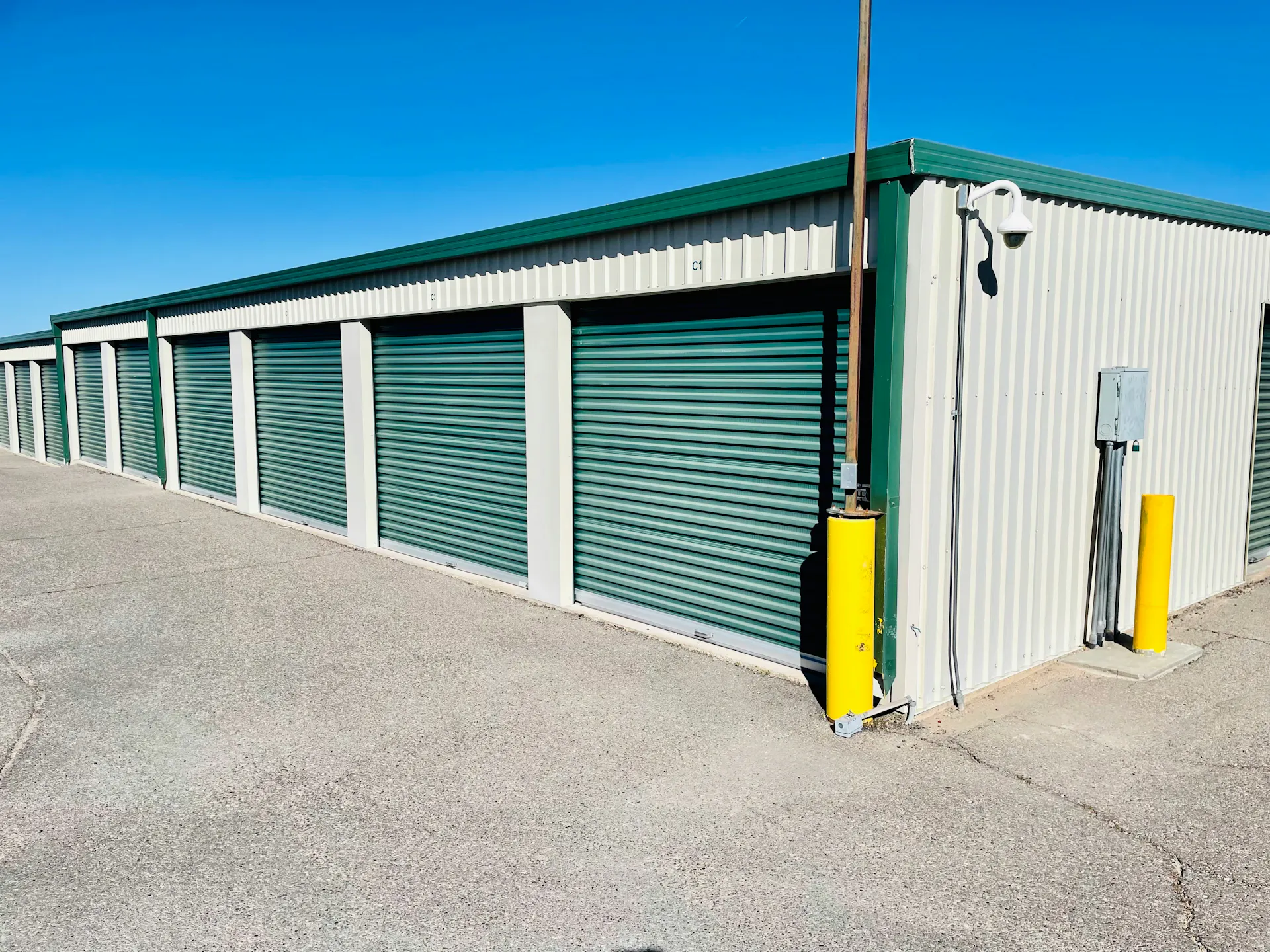 An outdoor, drive-up block of storage units.