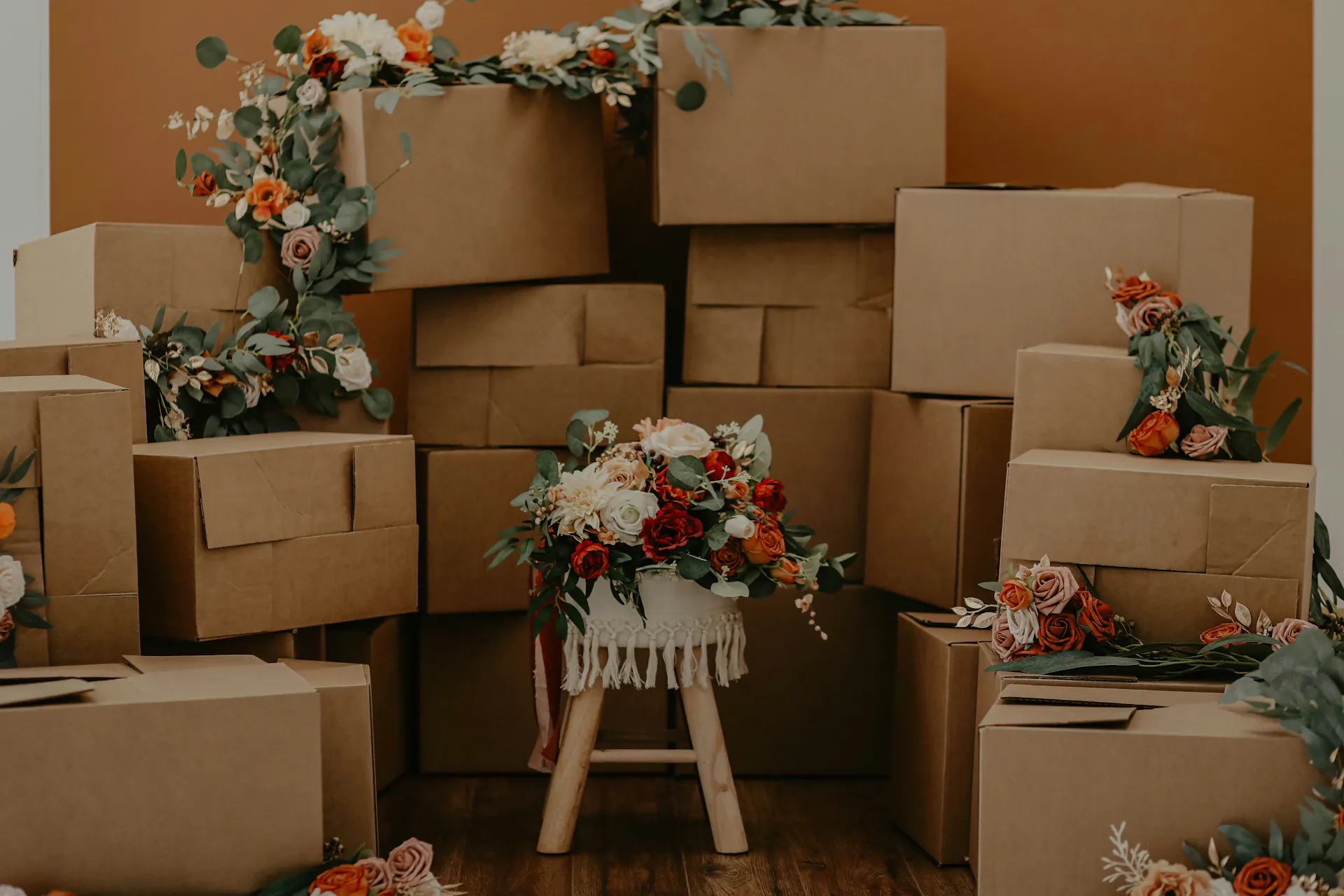 A stack of boxes and wedding centerpieces in a room.