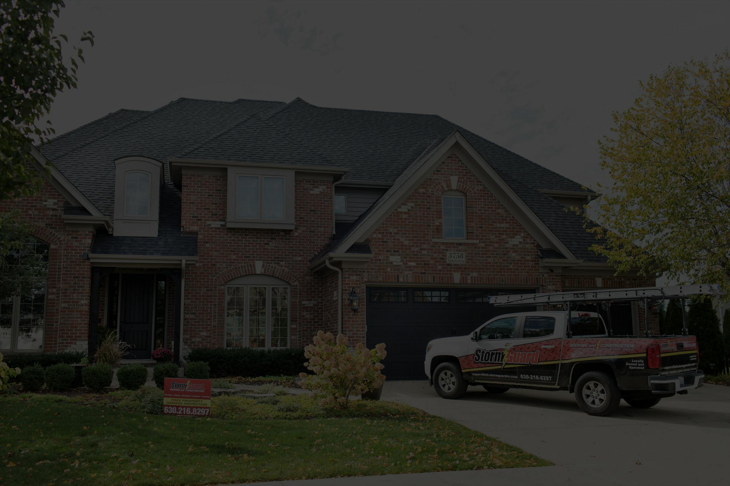 Storm Guard Roofing truck in front of roof replacement project