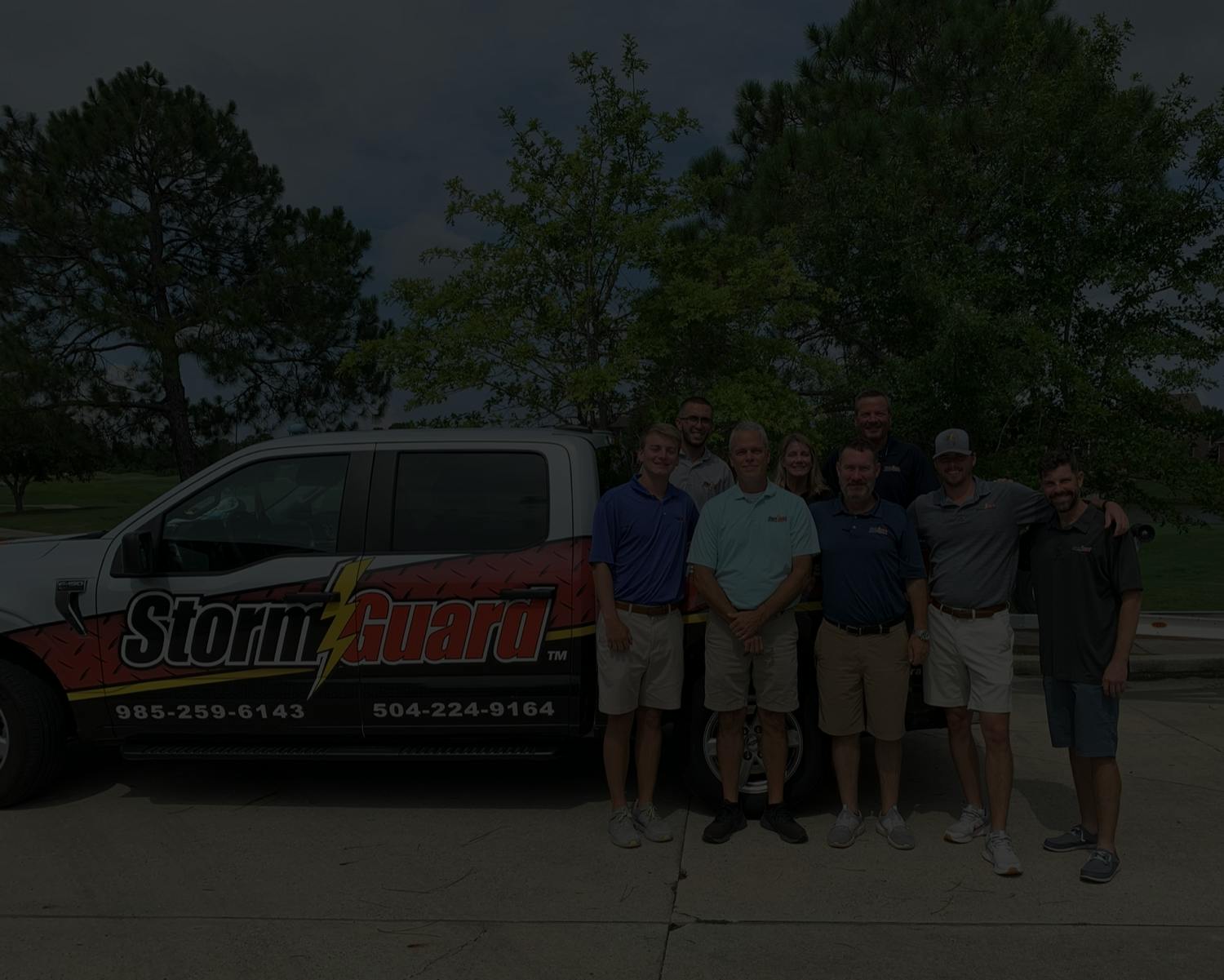 Storm Guard Roofing of New Orleans team standing in front of roofing truck