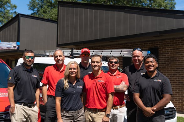 Storm Guard of Charlotte East Team Members in front of Storm Guard Roofing Truck