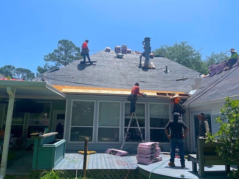 roofing contractors repairing a roof