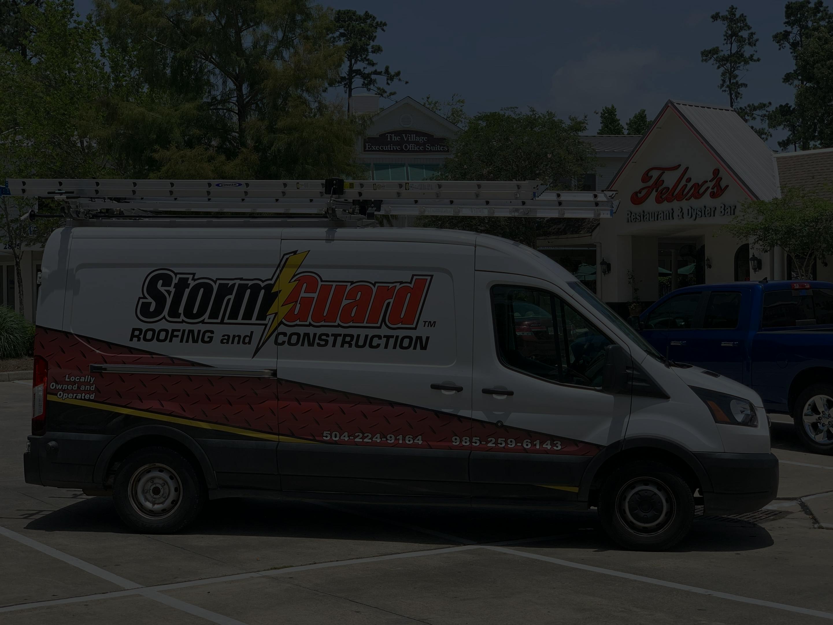 Storm Guard Roofing of Mandeville commercial roofing truck in front of local business