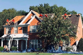 Storm Guard of Nashville Roof in Franklin, Tennessee with Storm Guard roofers working on roof