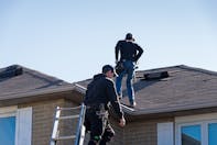 Roof Repair Contractors working on a damaged roof