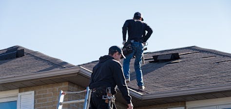 Roof Repair Contractors working on a damaged roof