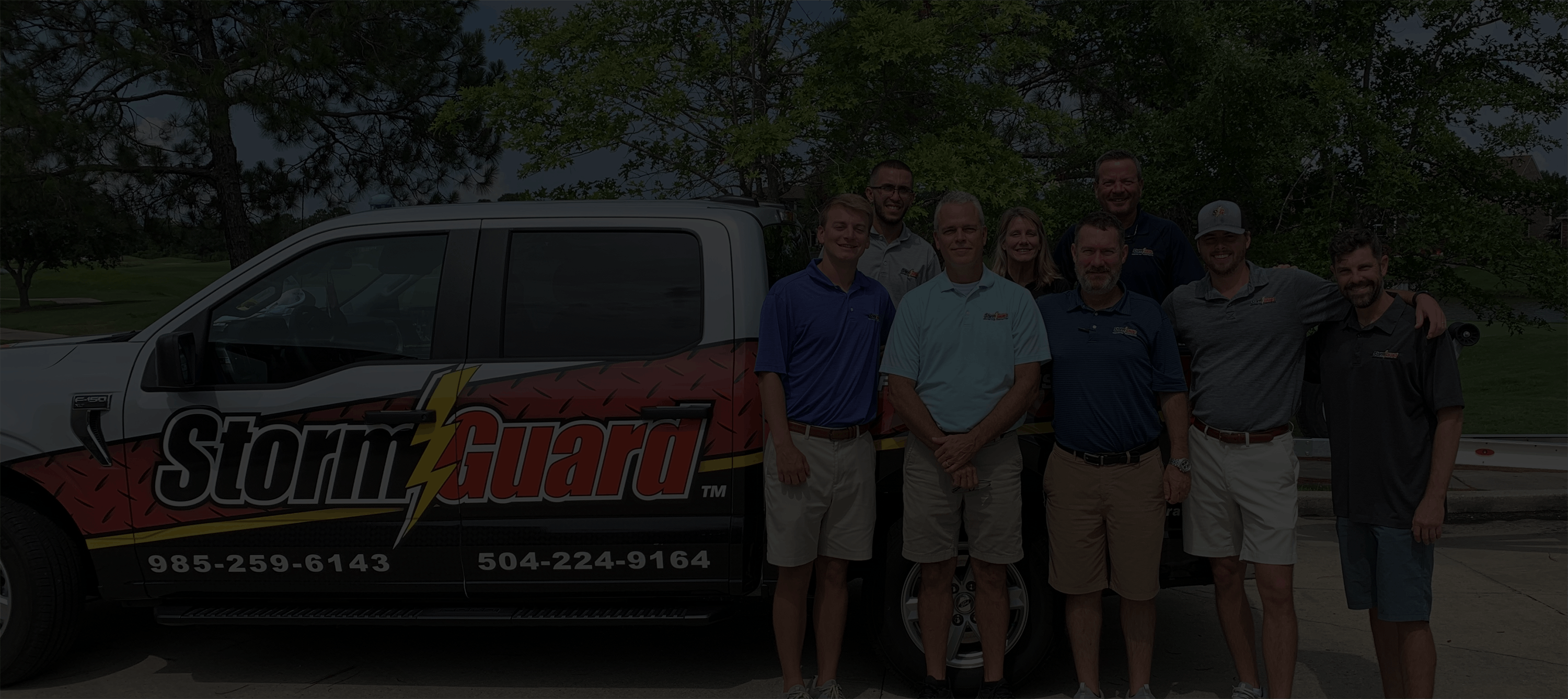 Storm Guard Roofing Truck with team in front of truck