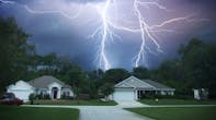 Lightning in the sky over houses