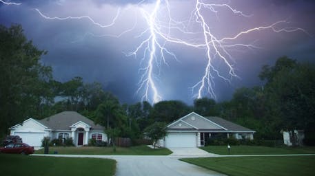 Lightning in the sky over houses