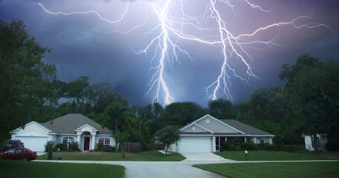 Lightning in the sky over houses