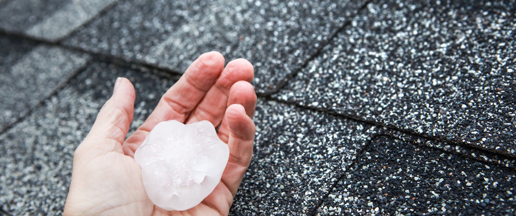 person holding large piece of hail