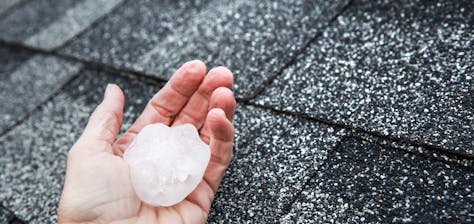 person holding large piece of hail