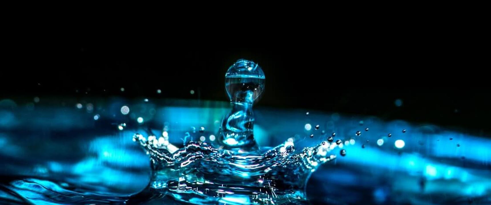 A Drip Splashing From a Roof Leak