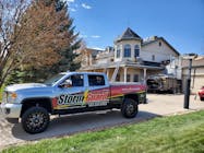 Storm Guard Roofing truck in front of roofing project