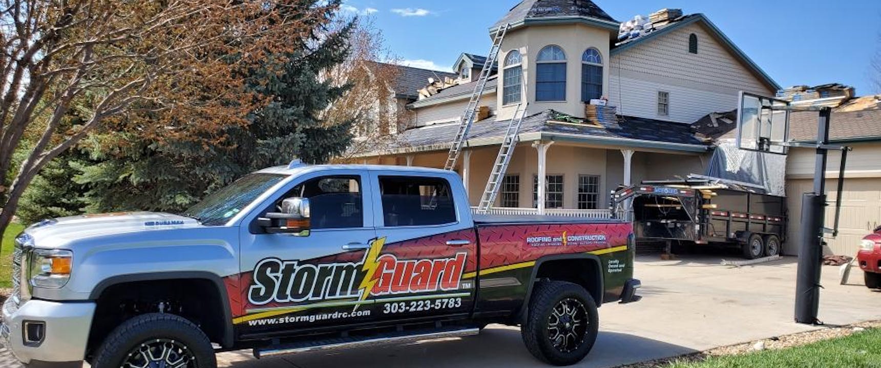 Storm Guard Roofing truck in front of roofing project