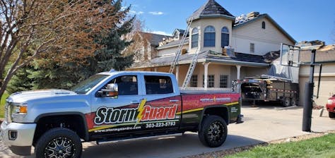 Storm Guard Roofing truck in front of roofing project