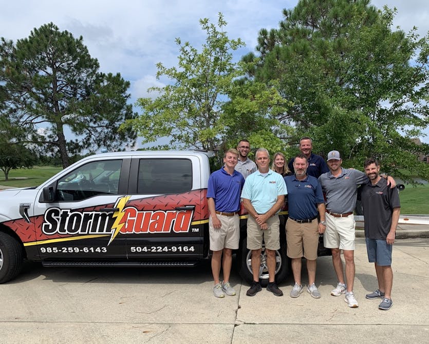 Storm Guard Roofing team in front of a roofing truck