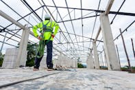 Commercial Roofer standing on commercial building