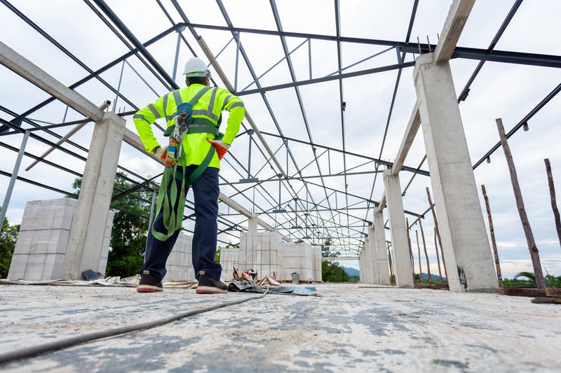 Commercial Roofer standing on commercial building