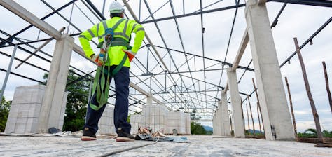 Commercial Roofer standing on commercial building