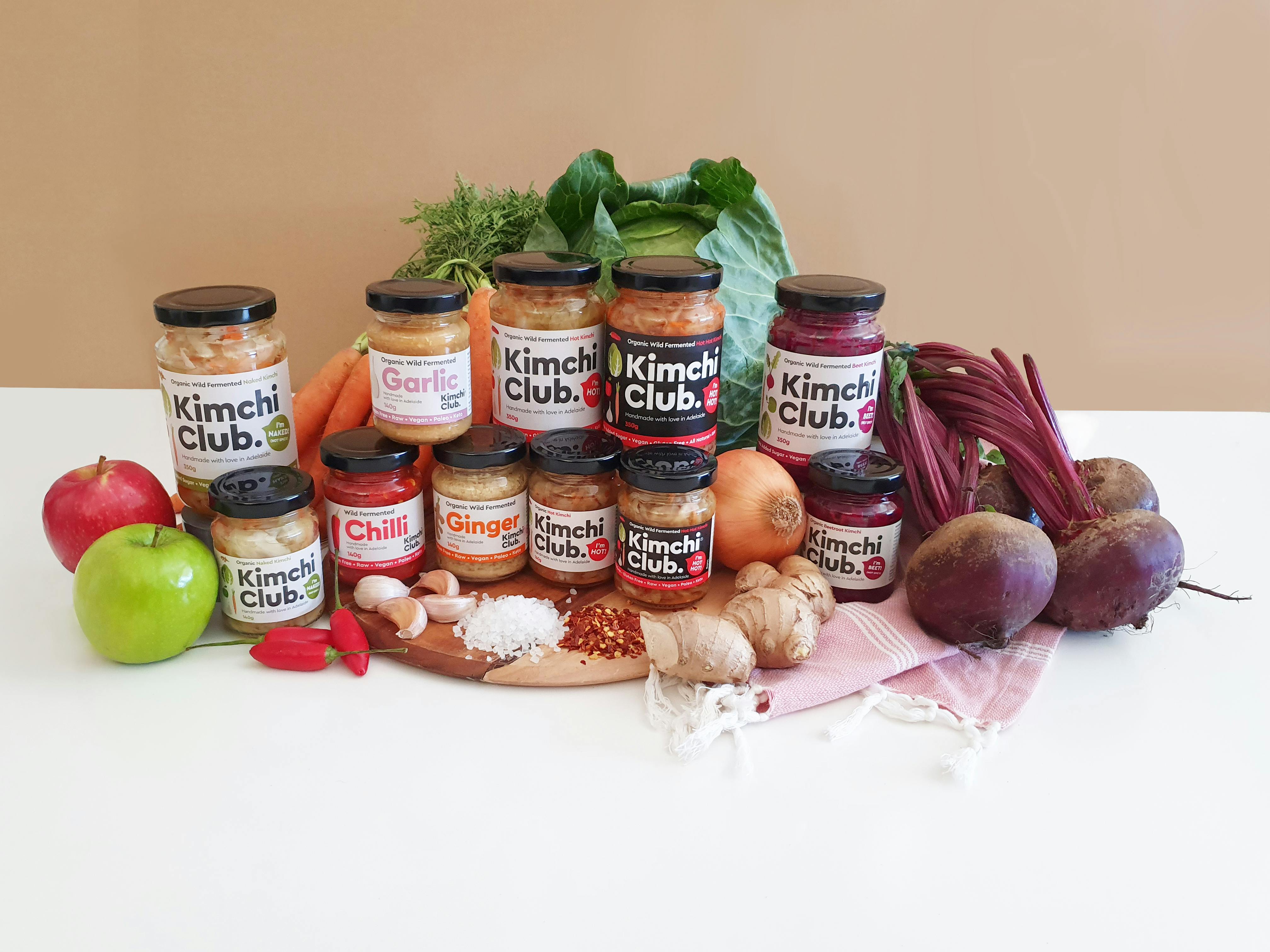 A range display of Kimchi Club products in jars