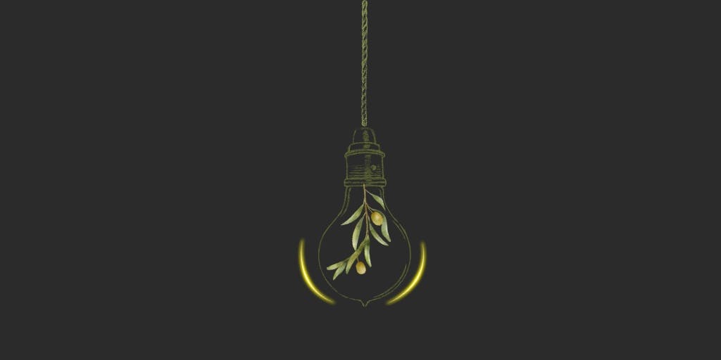 Lightbulb filled with olives on an olive branch hanging fromthe