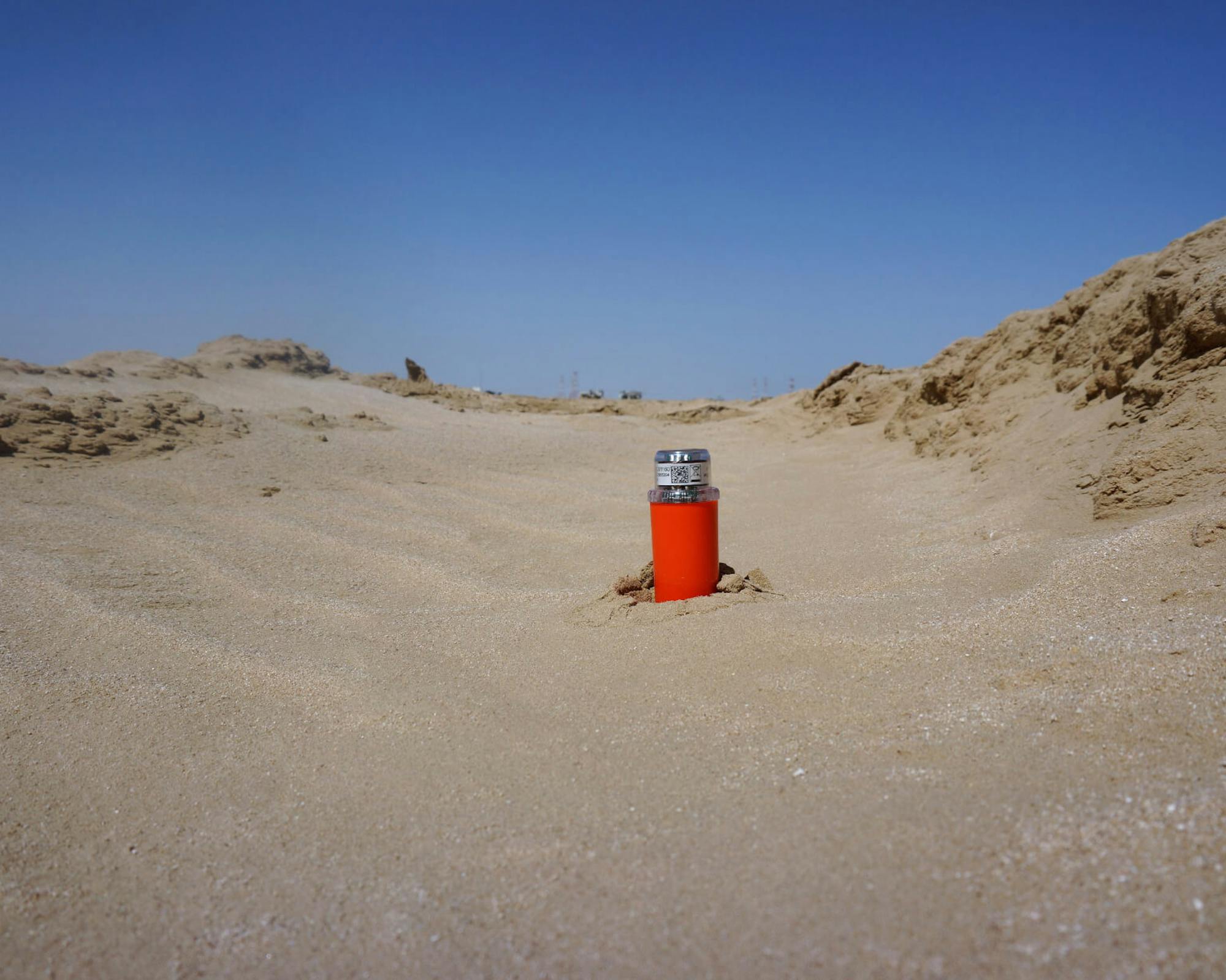 STRYDE node buried in the sand in the desert for seismic exploration and acquisition