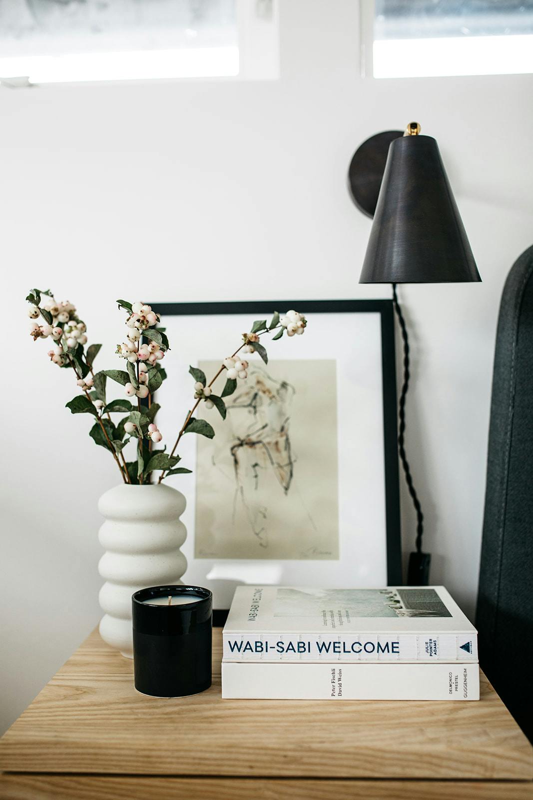 Table with plant, book, painting and lamp