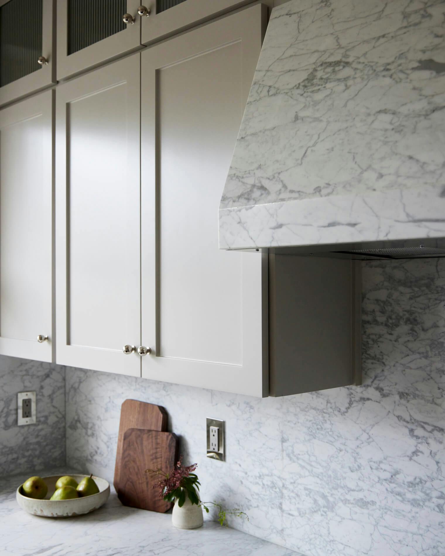 Kitchen cupboards and marble hood cover