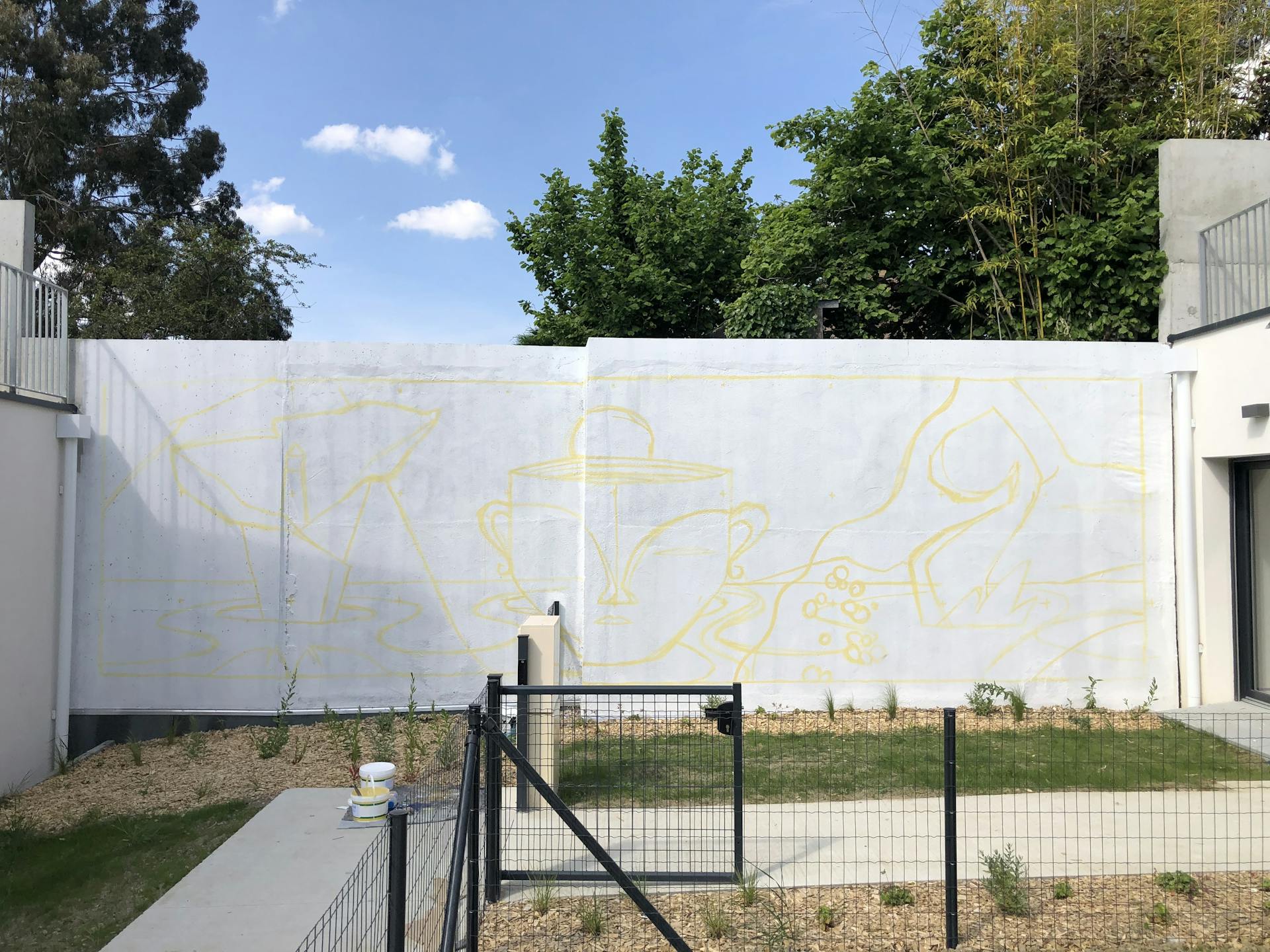 Traçage d'une oeuvre de street art sur le mur d'une cour d'immeuble, commanditée par Vinci Immobilier auprès du Studio Katra.