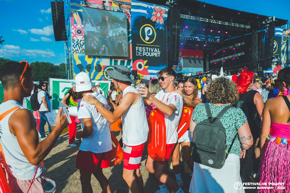 Des festivaliers du festival de Poupet, faisant la chenille devant une scène.