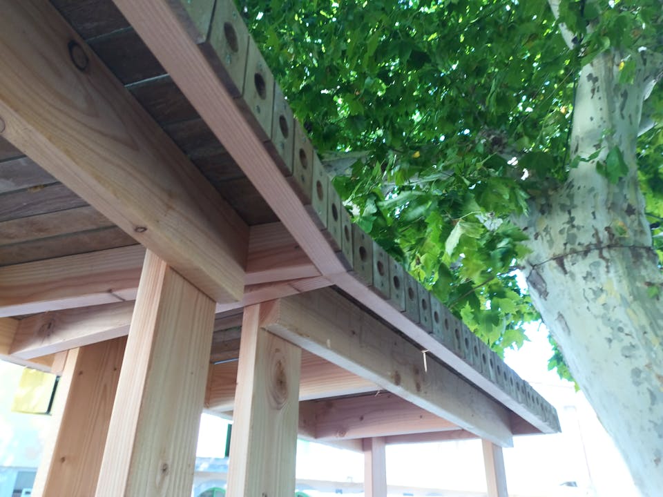 Une terrasse extérieure en bois réalisée sur la promenade Marcelin Albert du village d'Argeliers, par l'agence de design Studio Katra.