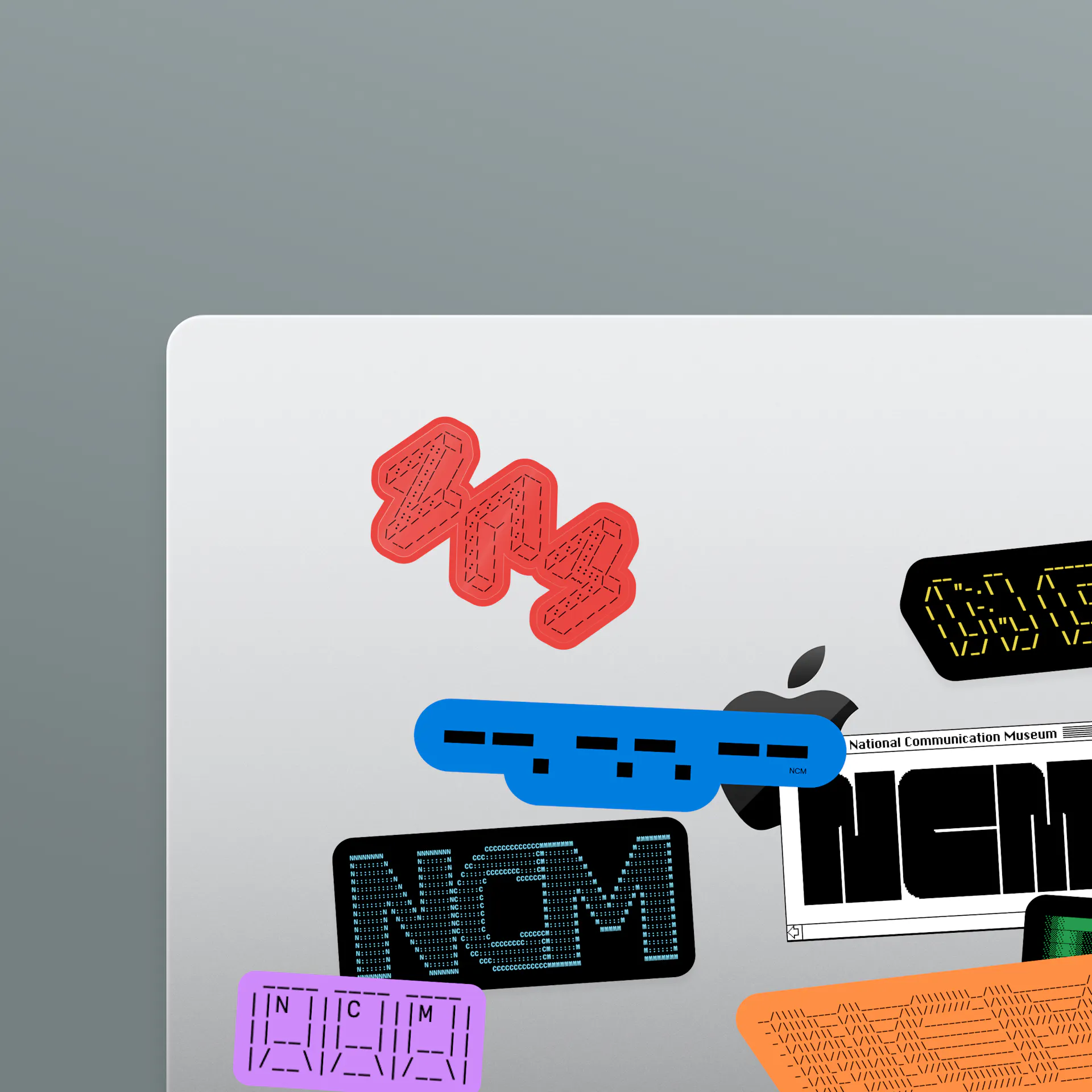 A selection of different NCM stickers on a laptop