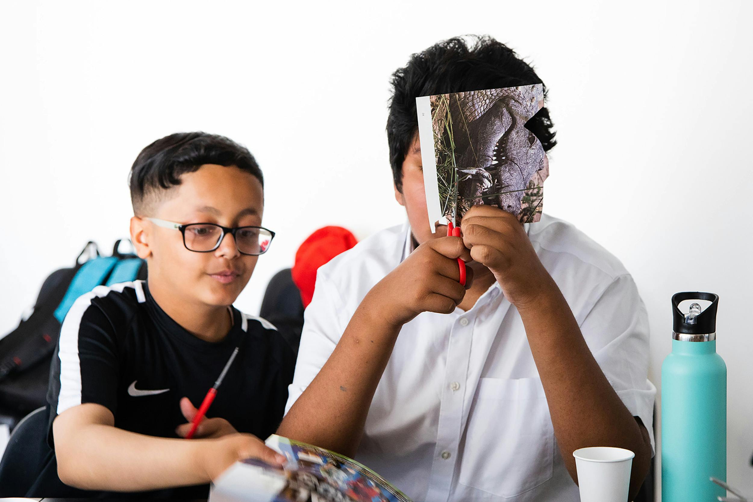 two young children participating in a creative collage workshop