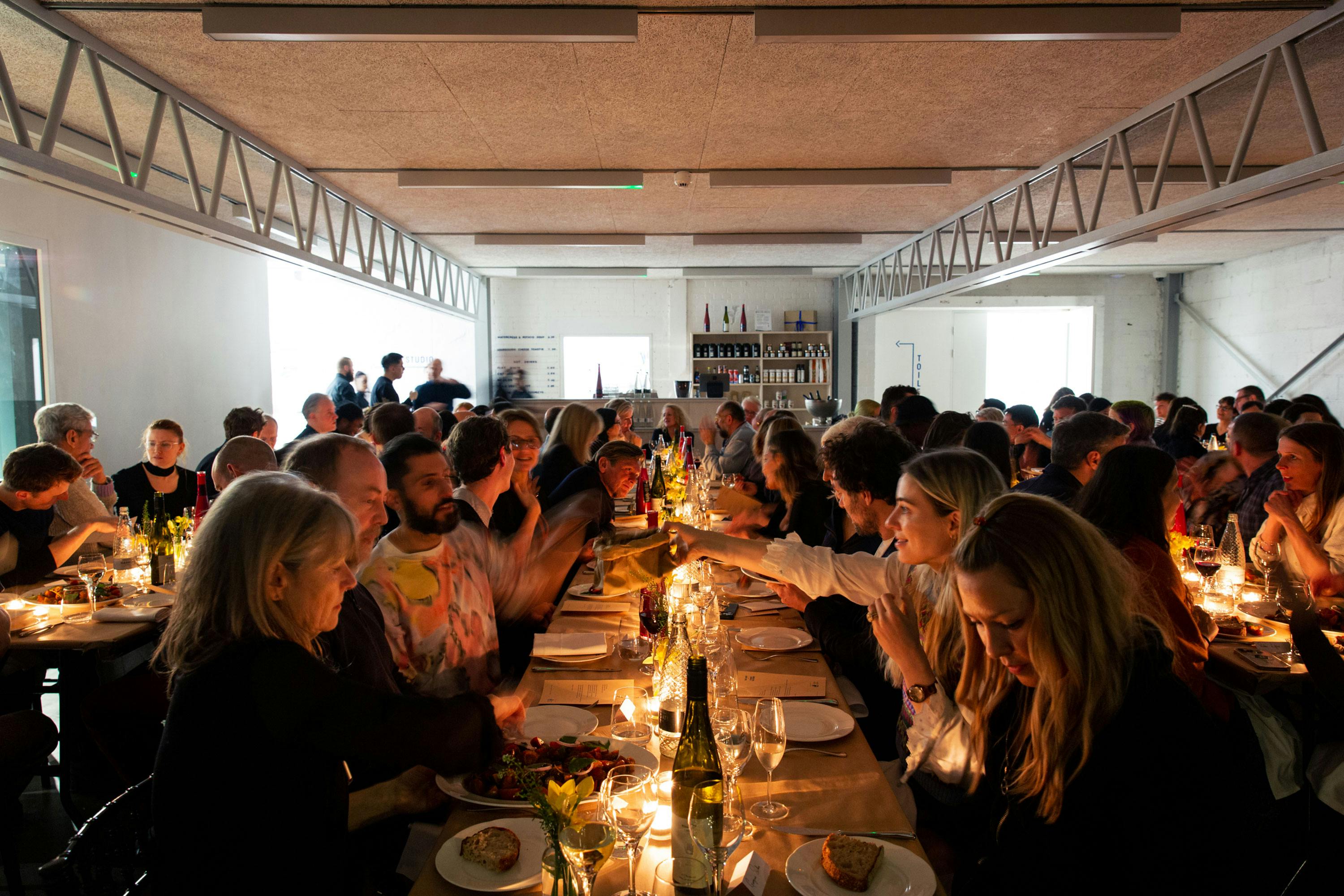 Rows of tables with diners enjoying a lively dinner hosted Studio Voltaire