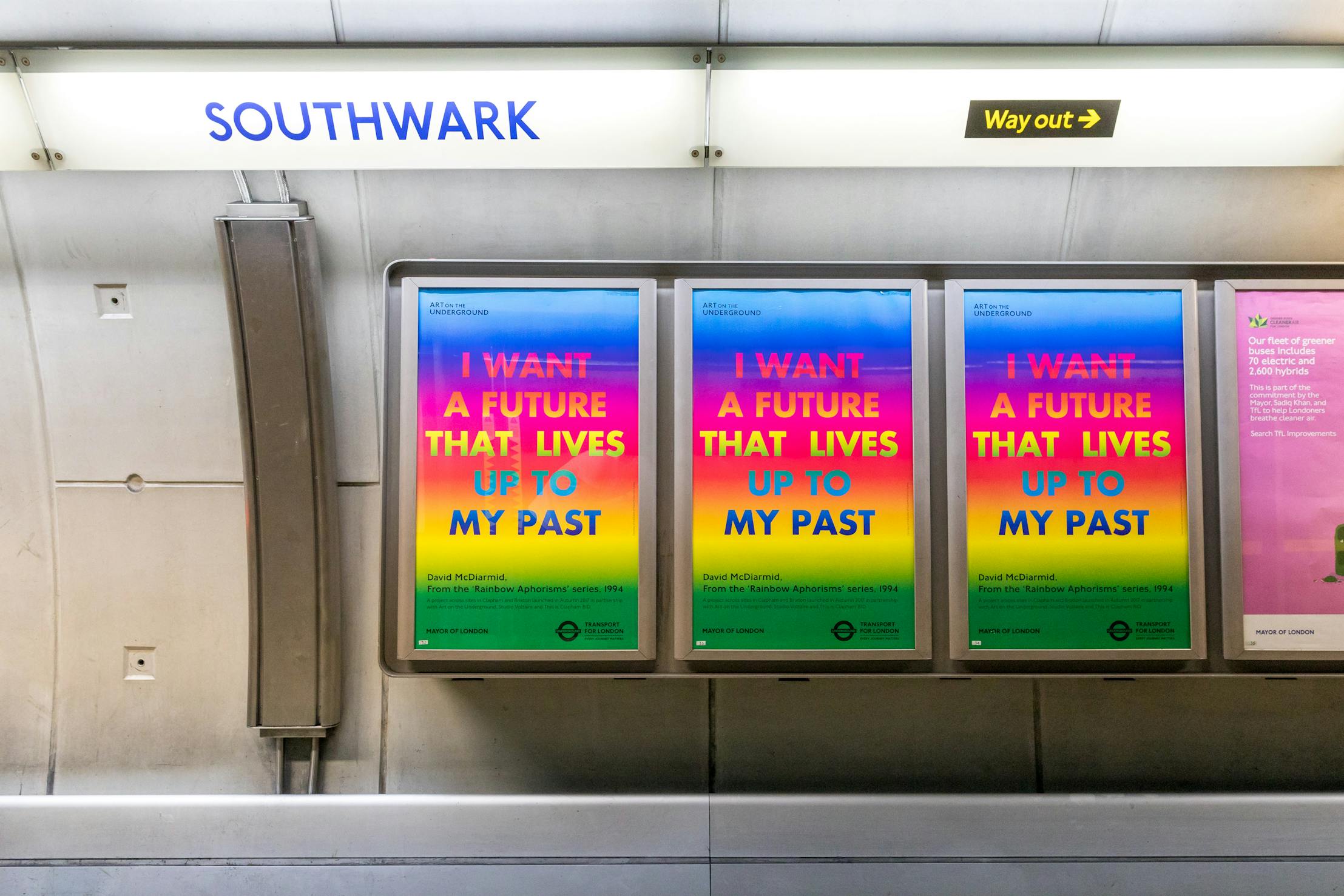 Posters by David McDiarmid at Southwark Underground station display the phrase "I WANT A FUTURE THAT LIVES UP TO MY PAST" in bold text on a colourful gradient background. Signs for "Southwark" and "Way out" are visible above.