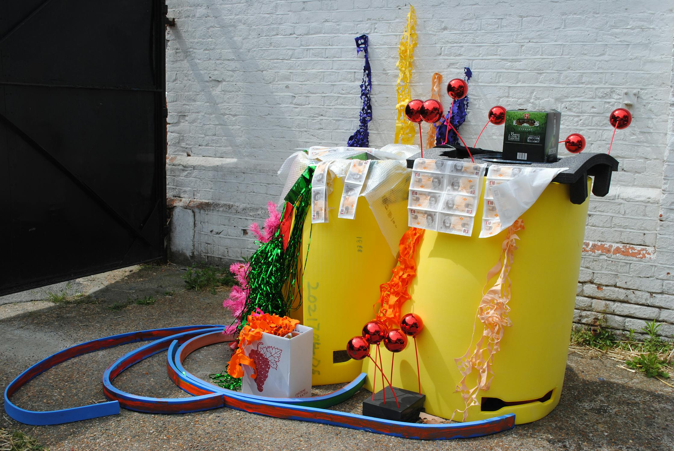 Pardip Kapil. Yard Installation. Foam, fabrics, boxes, baubles, Christmas tree, paper money. 2011. Image courtesy the Artist and ActionSpace