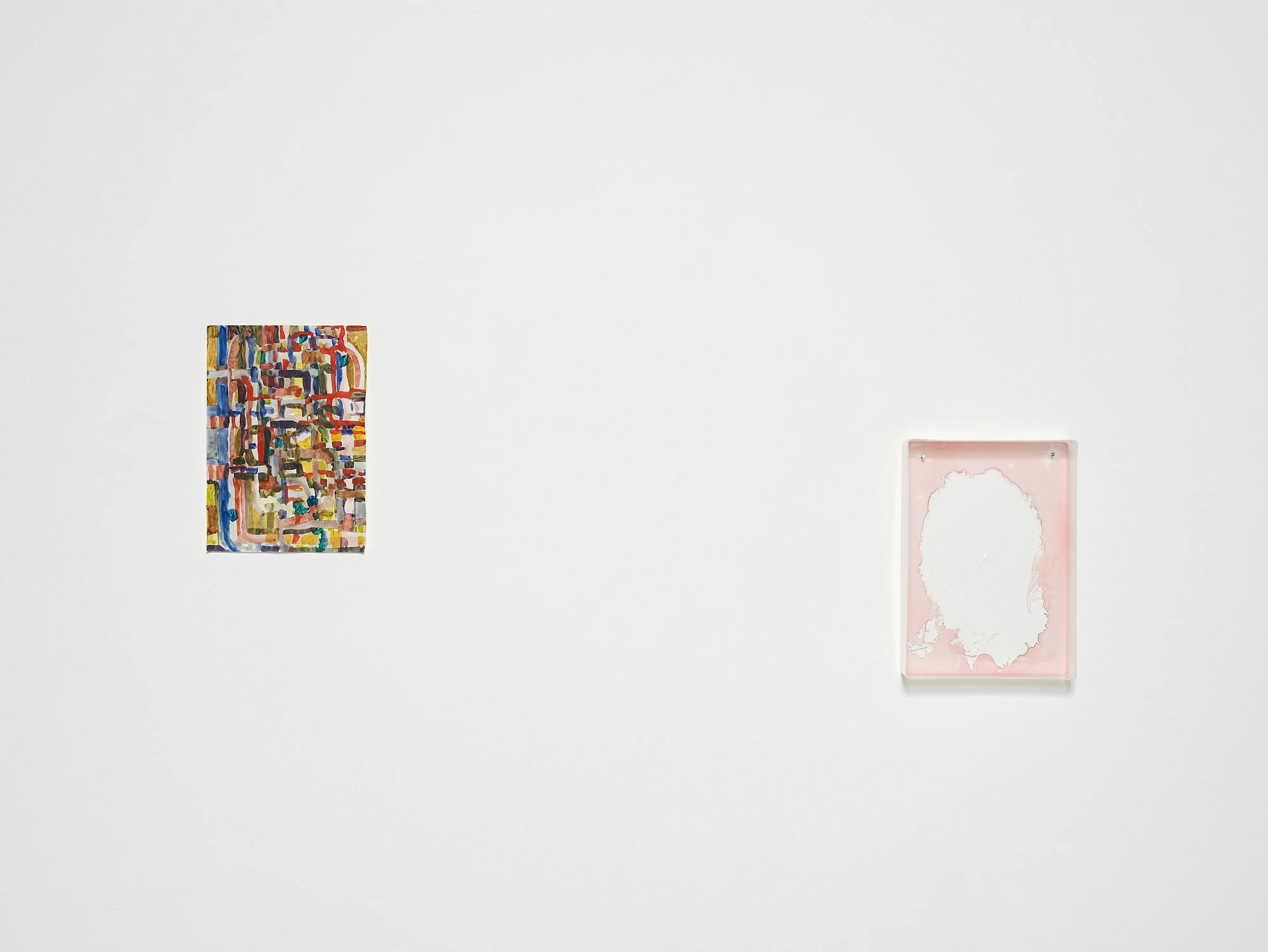 A white wall displays two artworks: left, a small, colourful, abstract painting with geometric shapes; right, a pink-framed piece with a white, textured area in the centre resembling peeling paint or paper. Both are spaced far apart.