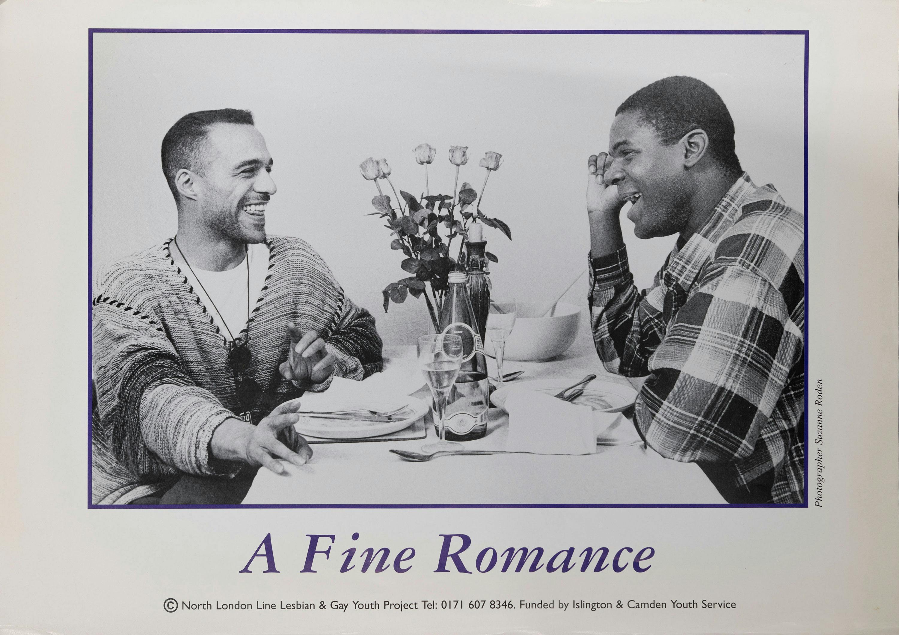 Two people sit across from each other at a dining table with white tablecloth. They are smiling and gazing at each other. A vase with roses is placed between them. Text at the bottom reads: "A Fine Romance.
