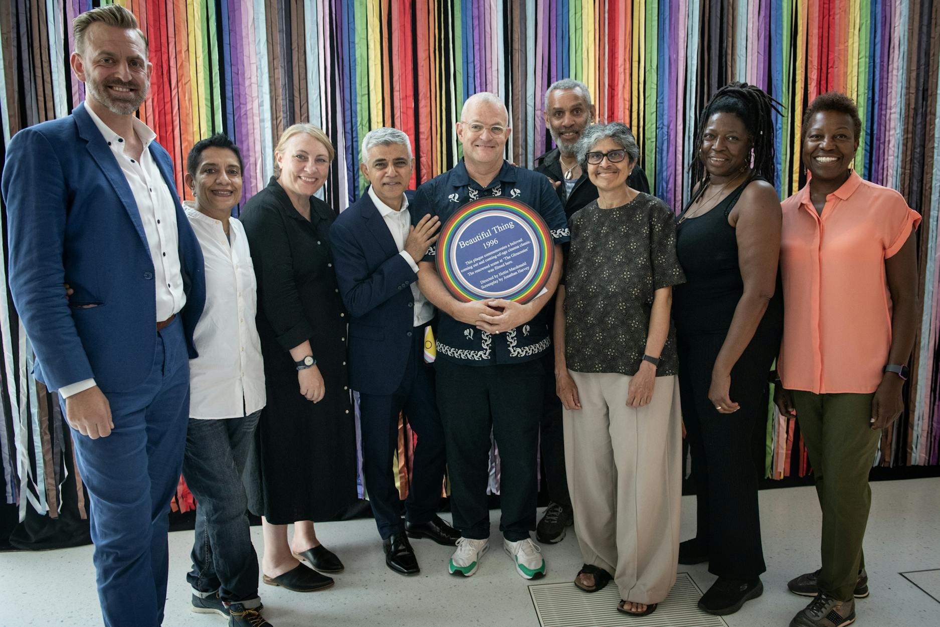 Mayor of London Sadiq Khan holding a Rainbow Plaque at the Mayor London's 2023 Pride Reception, surrounded by members of the Rainbow Plaque committee, funders and supporters