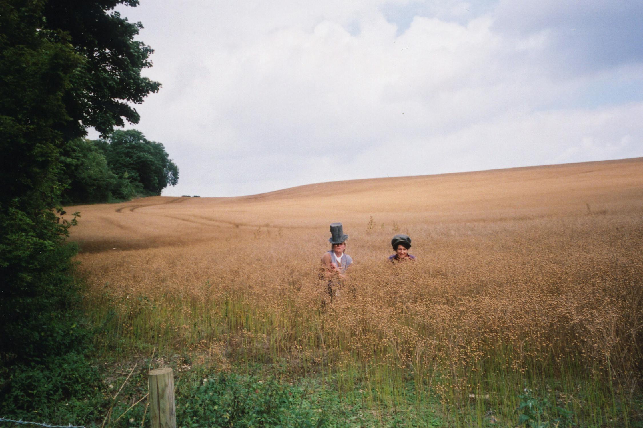 Film photograph of two people in high grass in a field